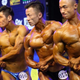Bodybuilders flexing onstage at competition